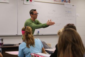 Picter of Joshua Davis speaking to small group