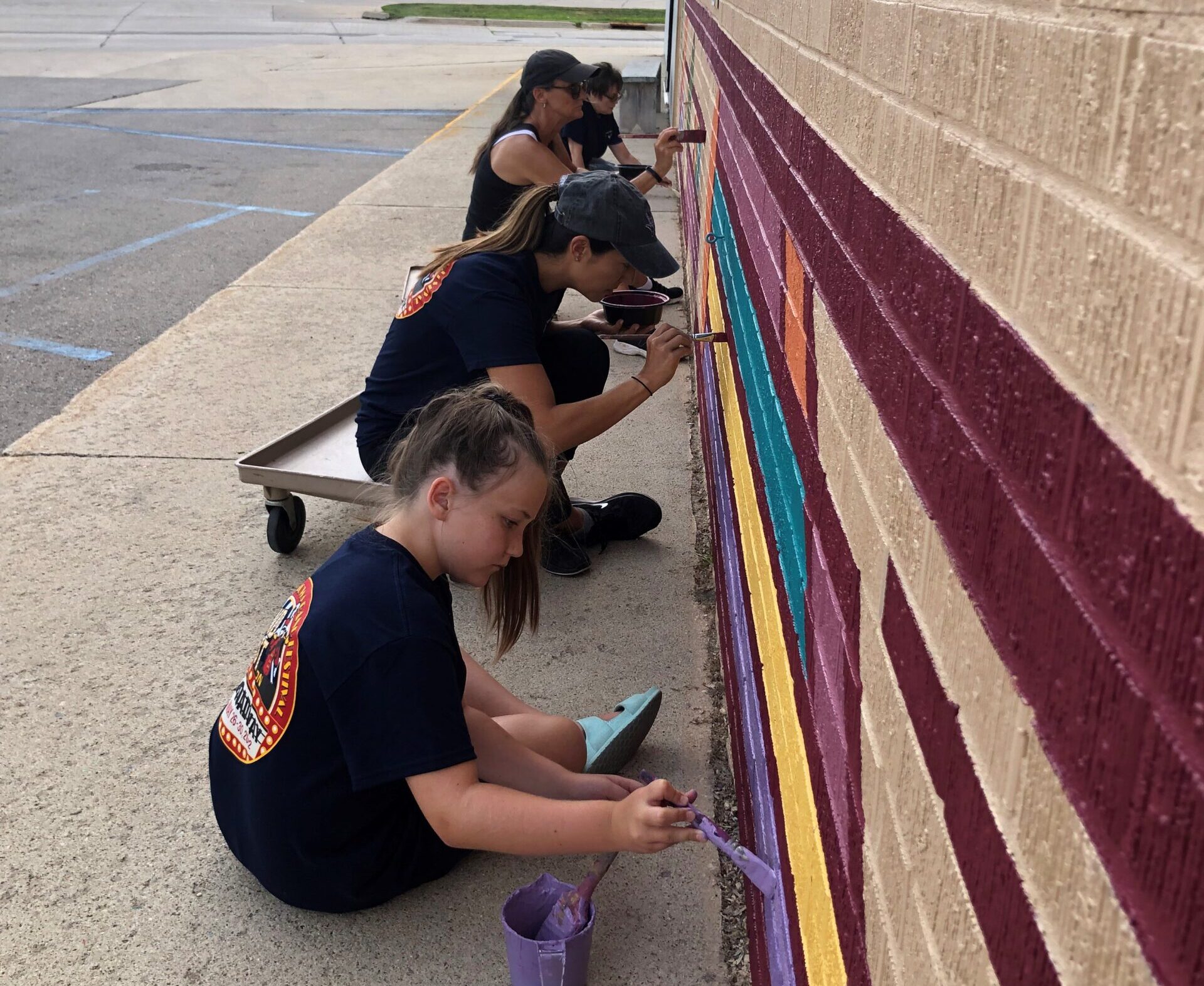 NIACC Volunteers painting mural