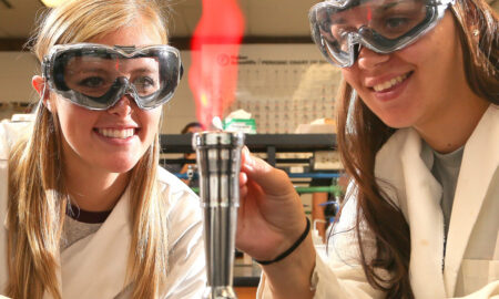 Two students using flame in STEM program