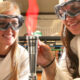 Two students using flame in STEM program