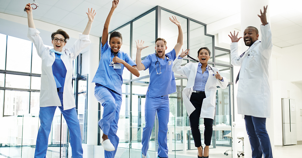 Healthcare staff jumping excitedly