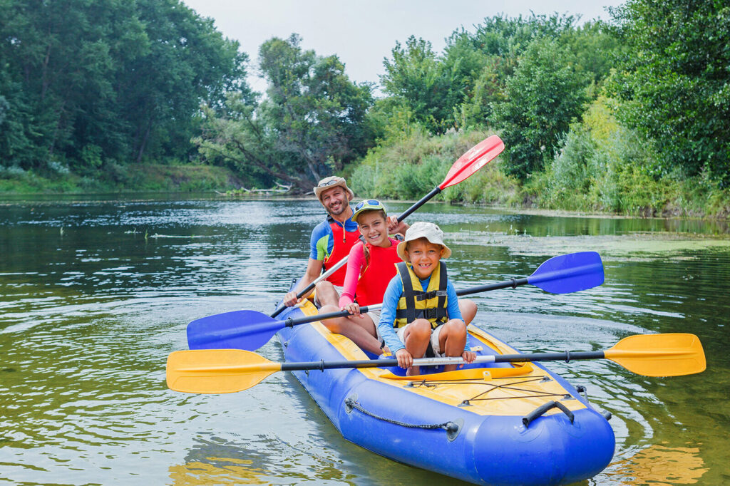 father and children kayaking