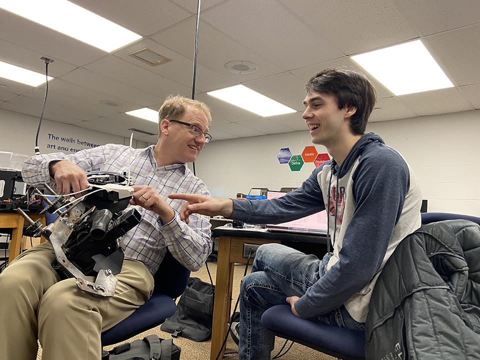 Two men discussing a project in NIACC's Innovation Workspace