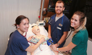 three nursing students in simulator lab