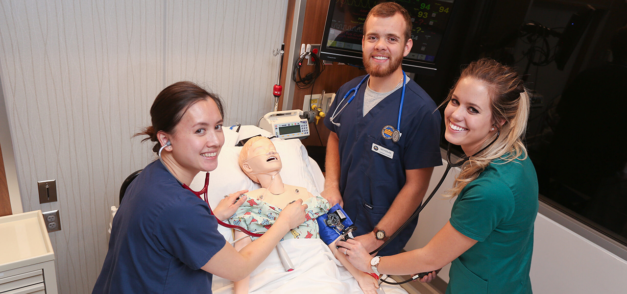 three nursing students in simulator lab