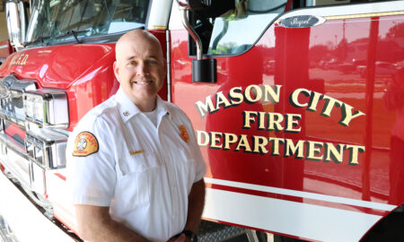 Aaron Beemer stands next to a fire engine