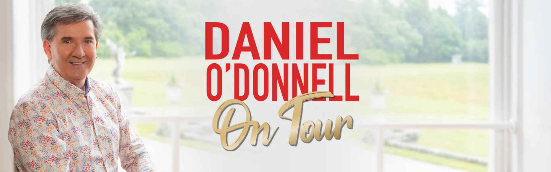 Promotional image for Daniel O'Donnell's tour, featuring Daniel O'Donnell smiling in a colorful shirt with the text 'Daniel O'Donnell On Tour' in red and gold, set against a scenic background.