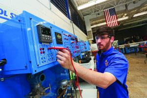 NIACC Student working on robotics equipment