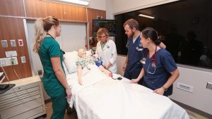 Photo of nursing students practicing in the Health Simulation Center