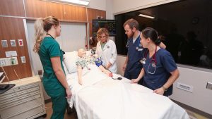 Photo of nursing students practicing in the Health Simulation Center