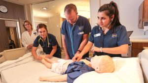 Photo of nursing students practicing in the Health Simulation Center