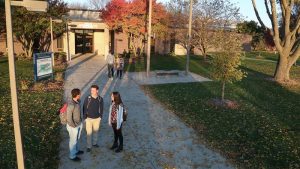 Photo of students standing outside the Pierce Administration Building