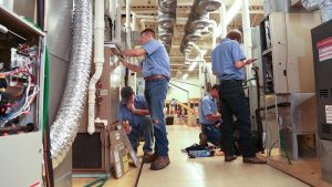 Photo of students working on HVAC systems