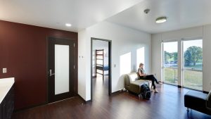 Photo of a student lounging in the Campus View Housing Complex