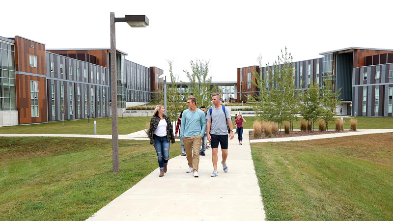 Photo of students walking to campus from the Campus View Housing complex