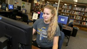 Photo of a student using a computer in the Beem Center library