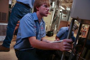 Picture of students working on HVAC unit