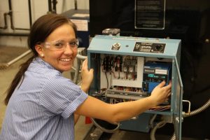 Picture of female student working on HVAC unit