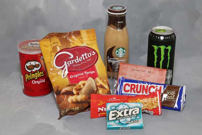 Picture of various food and drink items including Pringles, Gardetto's, Frappuccino, Monster Energy Drink, Popcorn, Crunch Candy Bar, Nut Roll, and Gum