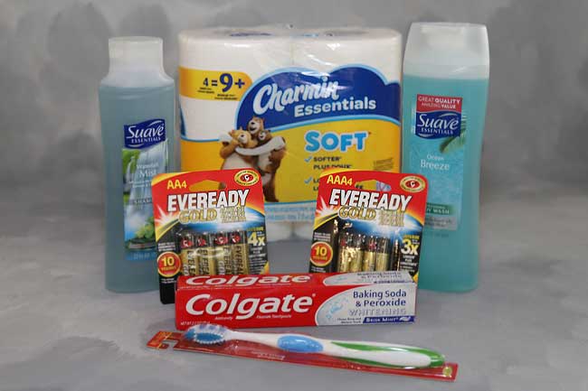 Picture of various necessities including Body Wash, Shampoo, Toilet Paper, Batteries, Toothpaste, and Tooth Brush