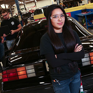 Photo of female NIACC student working in automotive