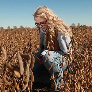 Photo of female NIACC student working in fields for Agriculture