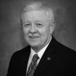 Picture of David Steffens (Man wearing a dark suit and tie with a NIACC pin)