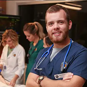 Photo of Nursing students with instructor, practicing in the Sim center