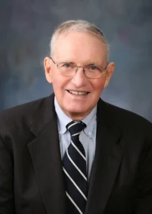 Man with glasses wearing a pinned striped suit and tie. (Jim Johnson)