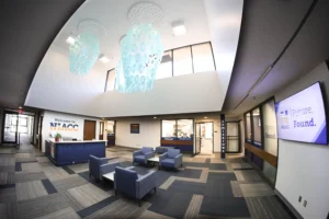 NIACC admissions area lobby with welcome desk, modern lighting, and seating area.