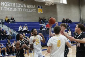 NIACC men’s basketball game in action with players from both teams under the basket.