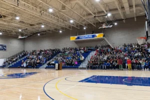 Crowded bleachers in NIACC gymnasium during a student assembly or presentation.