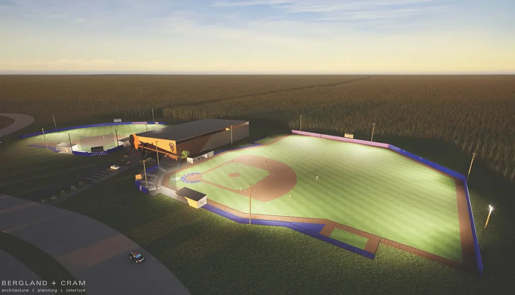Aerial architectural rendering of a baseball and softball complex at dusk, featuring illuminated fields, stadium seating, and an adjacent athletic facility building surrounded by trees.