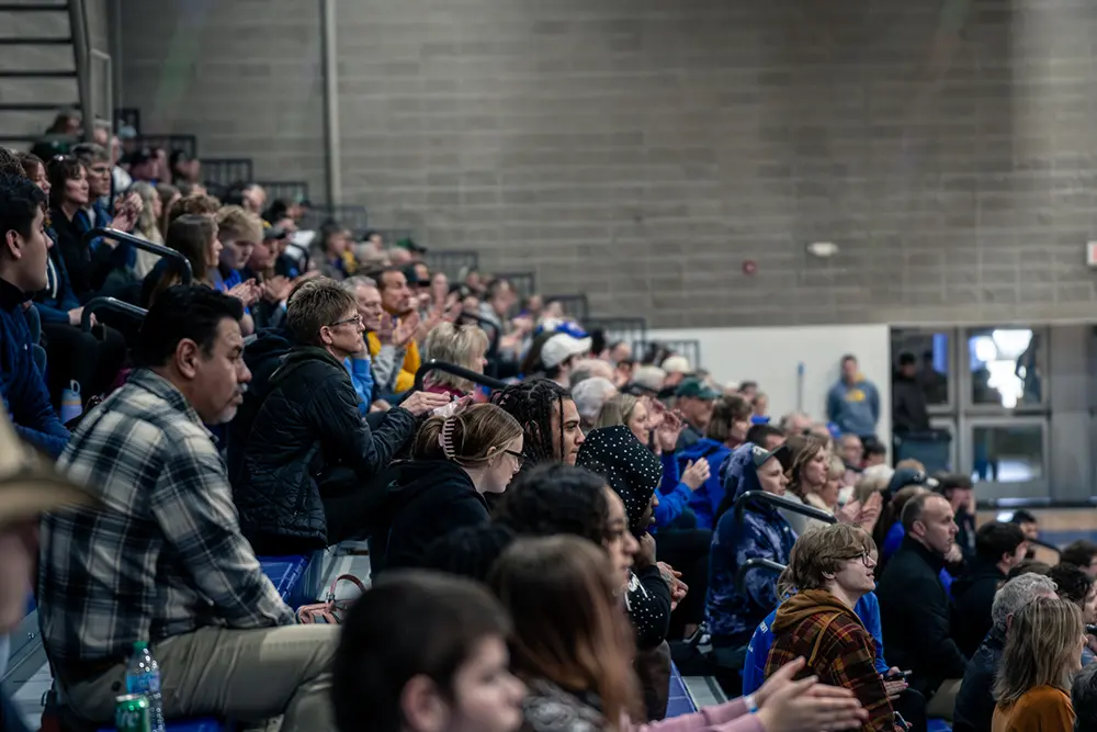 Spectators fill the bleachers and applaud during an event in the NIACC gymnasium.