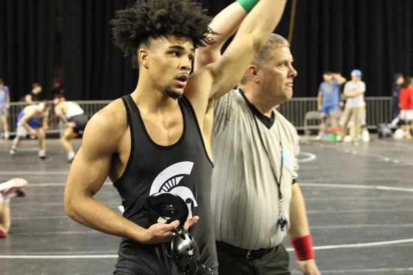 Picture of NIACC wrestler Christian Minto with his hand raised after a match