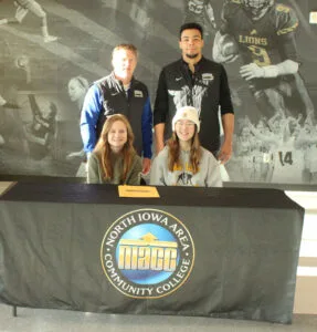 Picture of Haley and Chloe with wrestling coaches after signing to wrestle